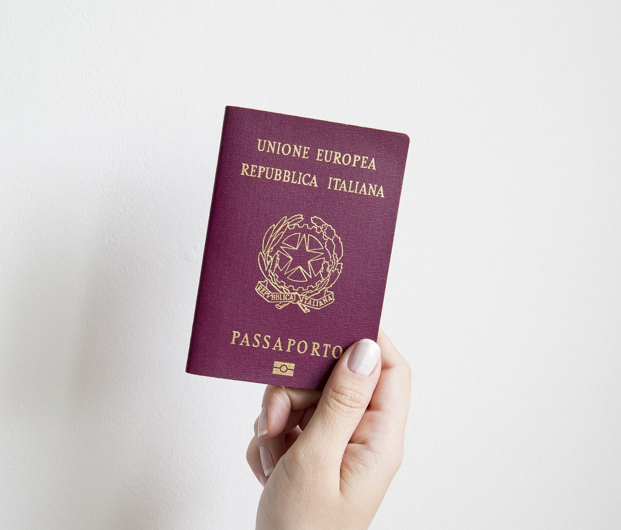 Arm holding passport for immigration purpose.